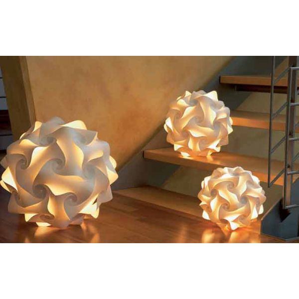 Drei leuchtende Sphere Lichtobjekte mit wirbelnden geometrischen Mustern sind auf Stufen und einem Holzboden im Innenbereich platziert und präsentieren exquisite handgefertigte Leuchten.